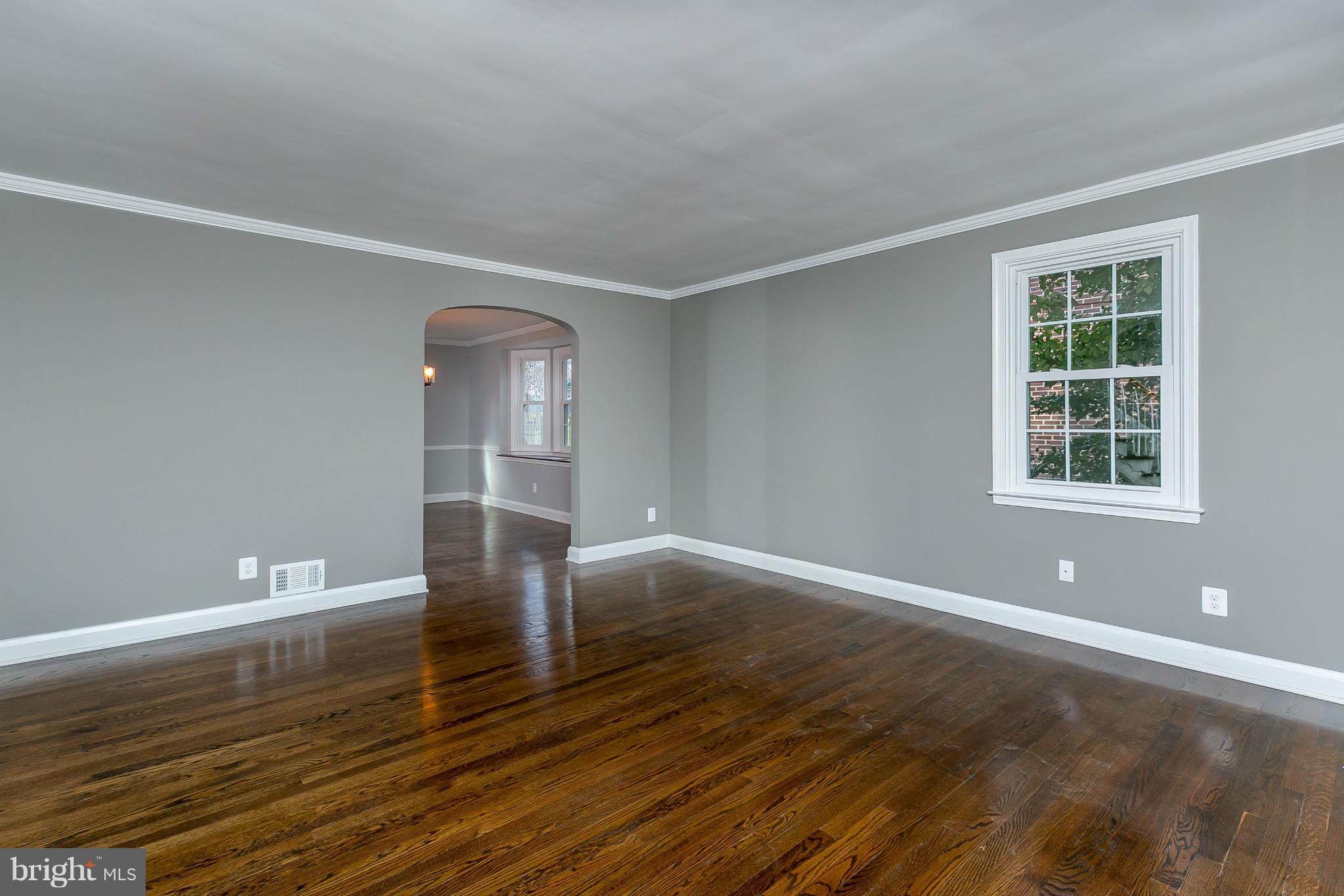 7126 Heathfield Road Baltimore, MD 21212 - Photo 7 of 23 a view of empty room with wooden floor and fan
