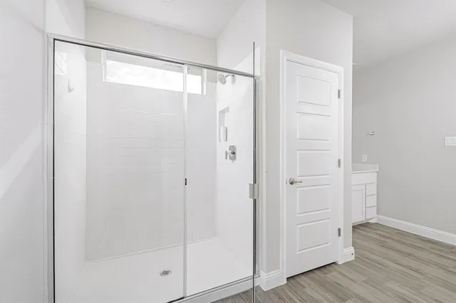 a bathroom with a glass shower door