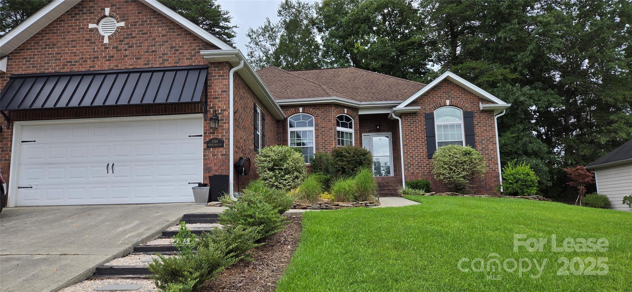 a house with green field in front of it