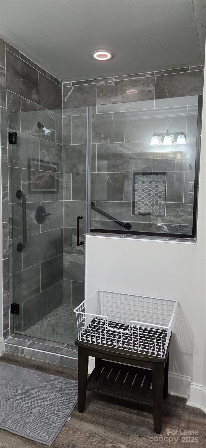 1144 Blowing Rock Cove Fort Mill, SC 29708 - Photo 13 of 23 a bathroom with a glass shower door and a wooden table
