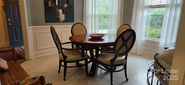a view of a dining room with furniture and window