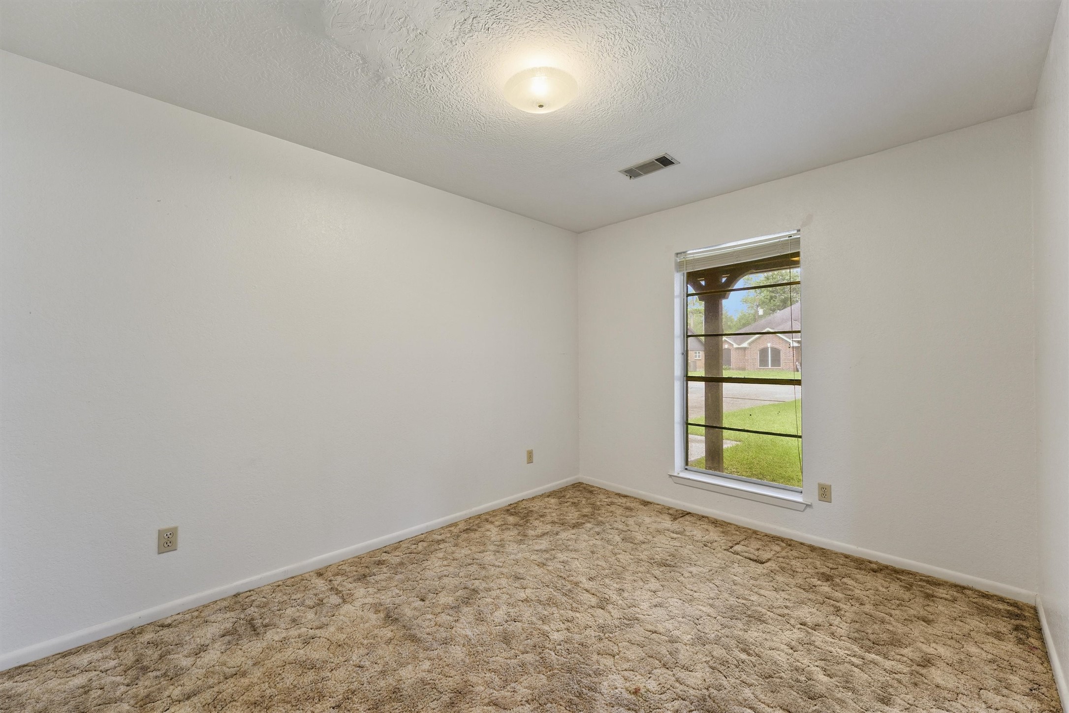 5103 Forest Trail Baytown, TX 77521 - Photo 18 of 25 an empty room with windows