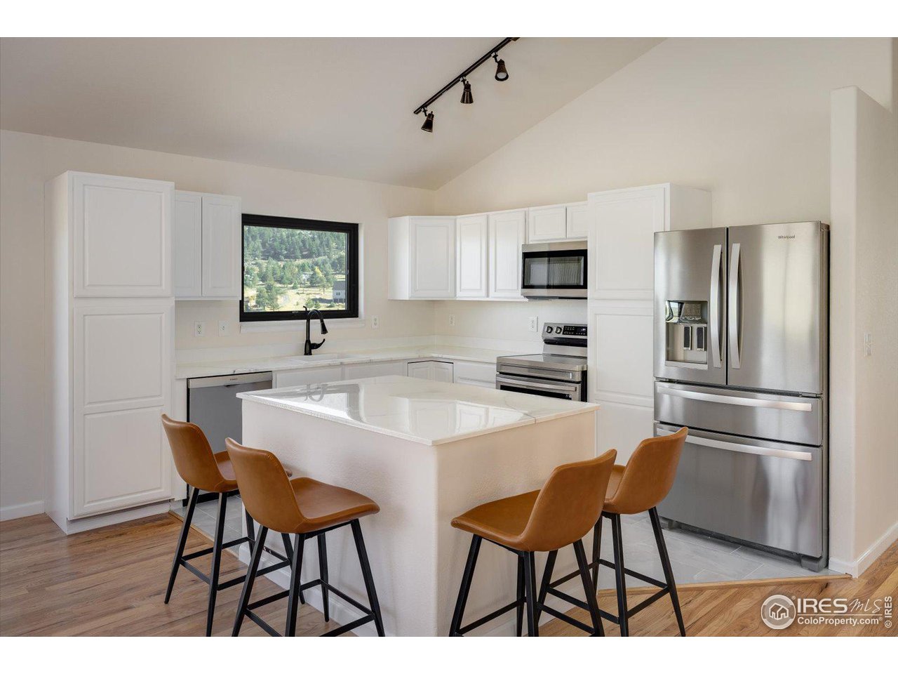 147 Makah Lane Lyons, CO 80540 - Photo 10 of 39 a kitchen with stainless steel appliances a refrigerator and a stove top oven