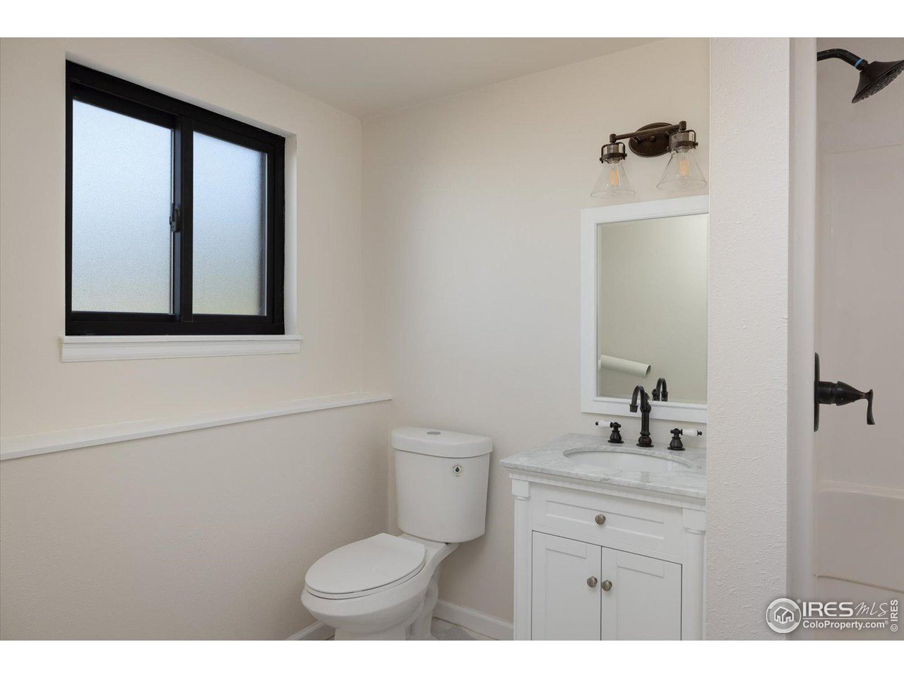 147 Makah Lane Lyons, CO 80540 - Photo 19 of 39 a bathroom with a toilet a sink a mirror and a window