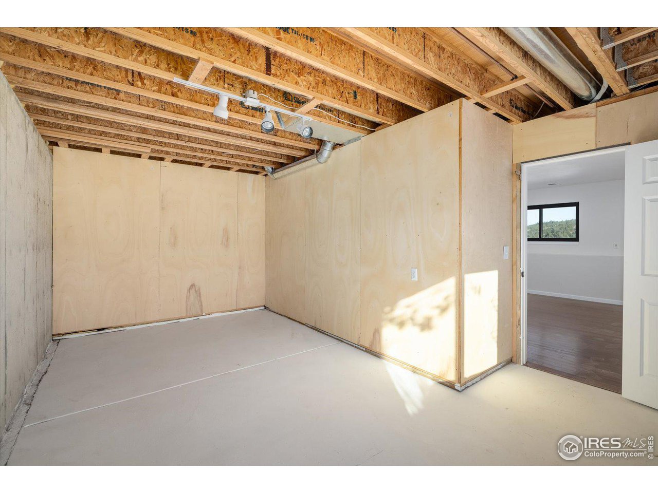 147 Makah Lane Lyons, CO 80540 - Photo 20 of 39 a view of a big room with wooden floor and door
