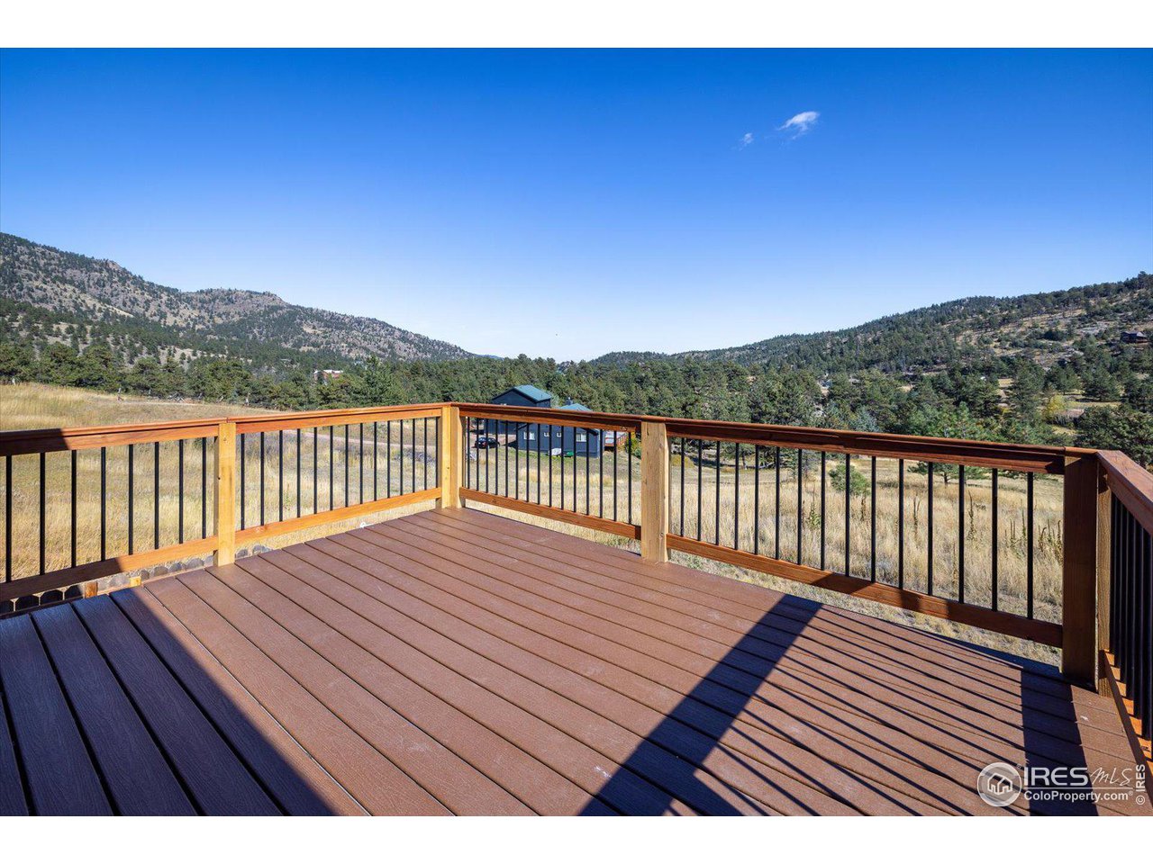 147 Makah Lane Lyons, CO 80540 - Photo 26 of 39 a view of deck with wooden floor and mountain view