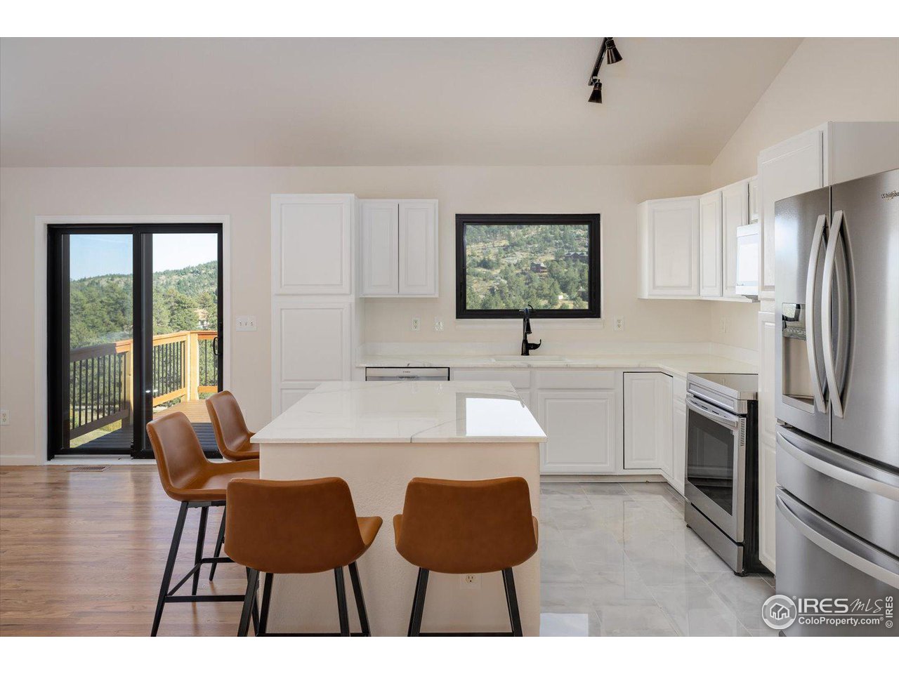 147 Makah Lane Lyons, CO 80540 - Photo 4 of 39 a view of kitchen and dining area with a sink wooden floor