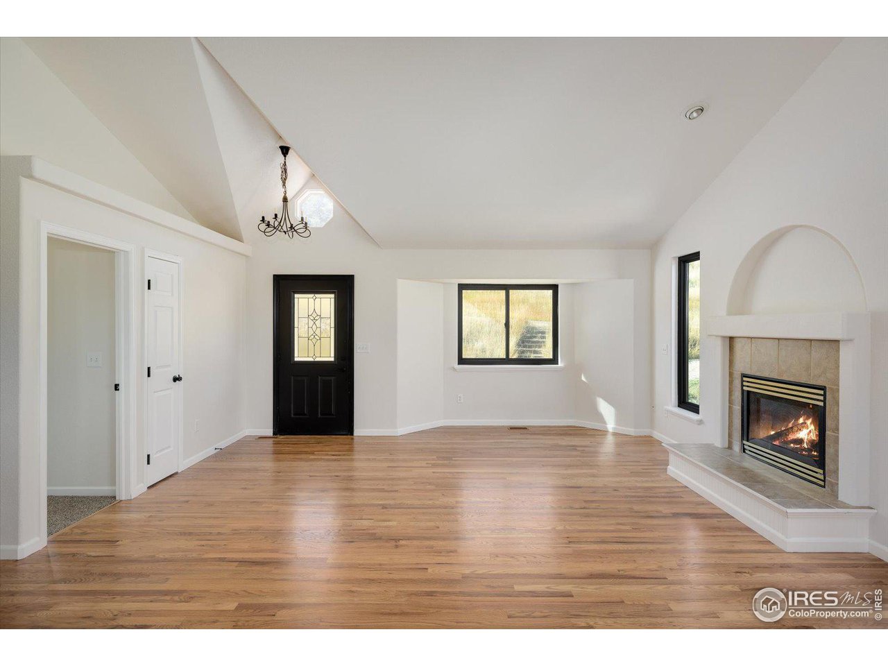 147 Makah Lane Lyons, CO 80540 - Photo 5 of 39 a view of an empty room with window and fire place