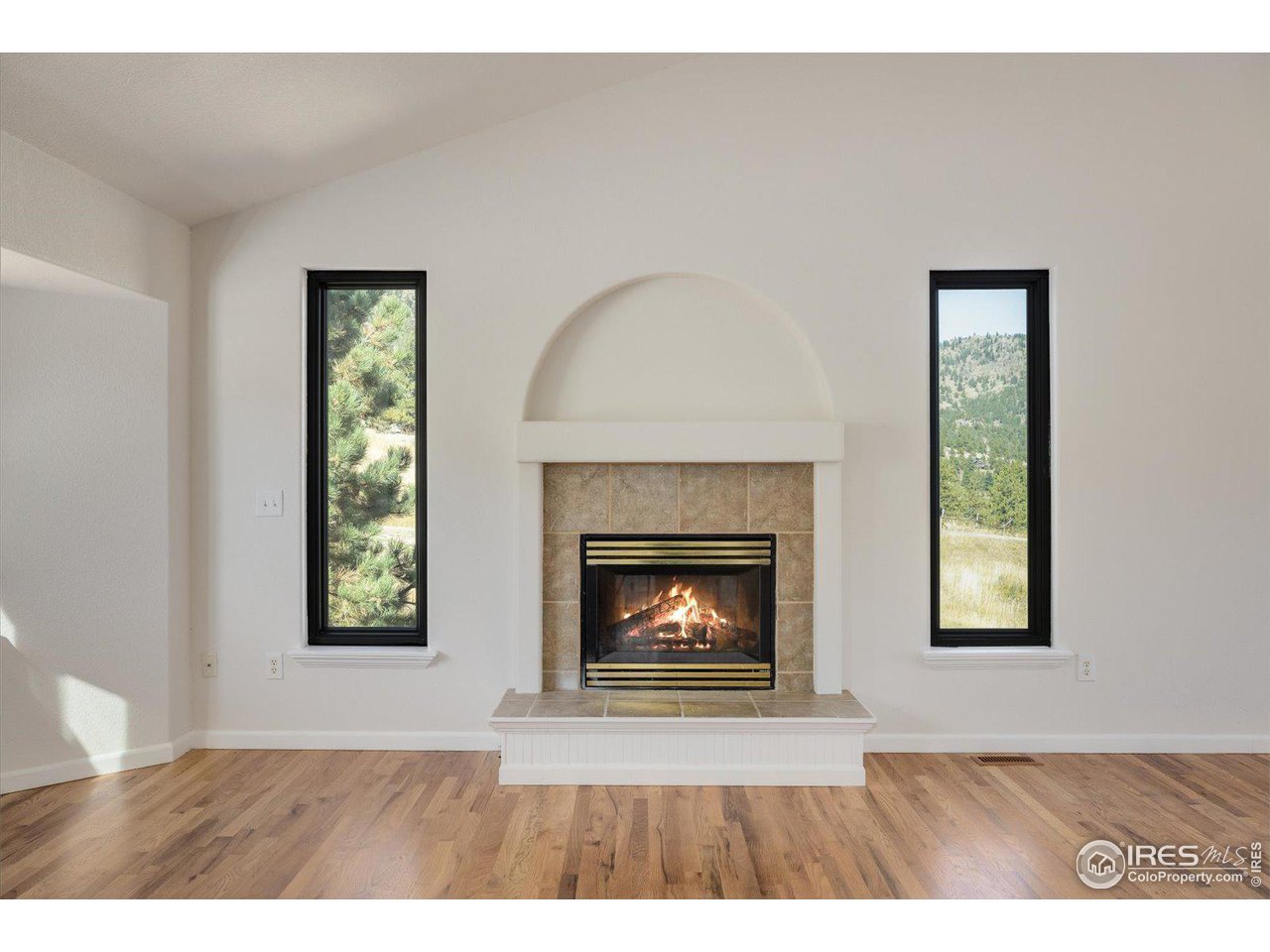 147 Makah Lane Lyons, CO 80540 - Photo 7 of 39 a living room with a fireplace and a window
