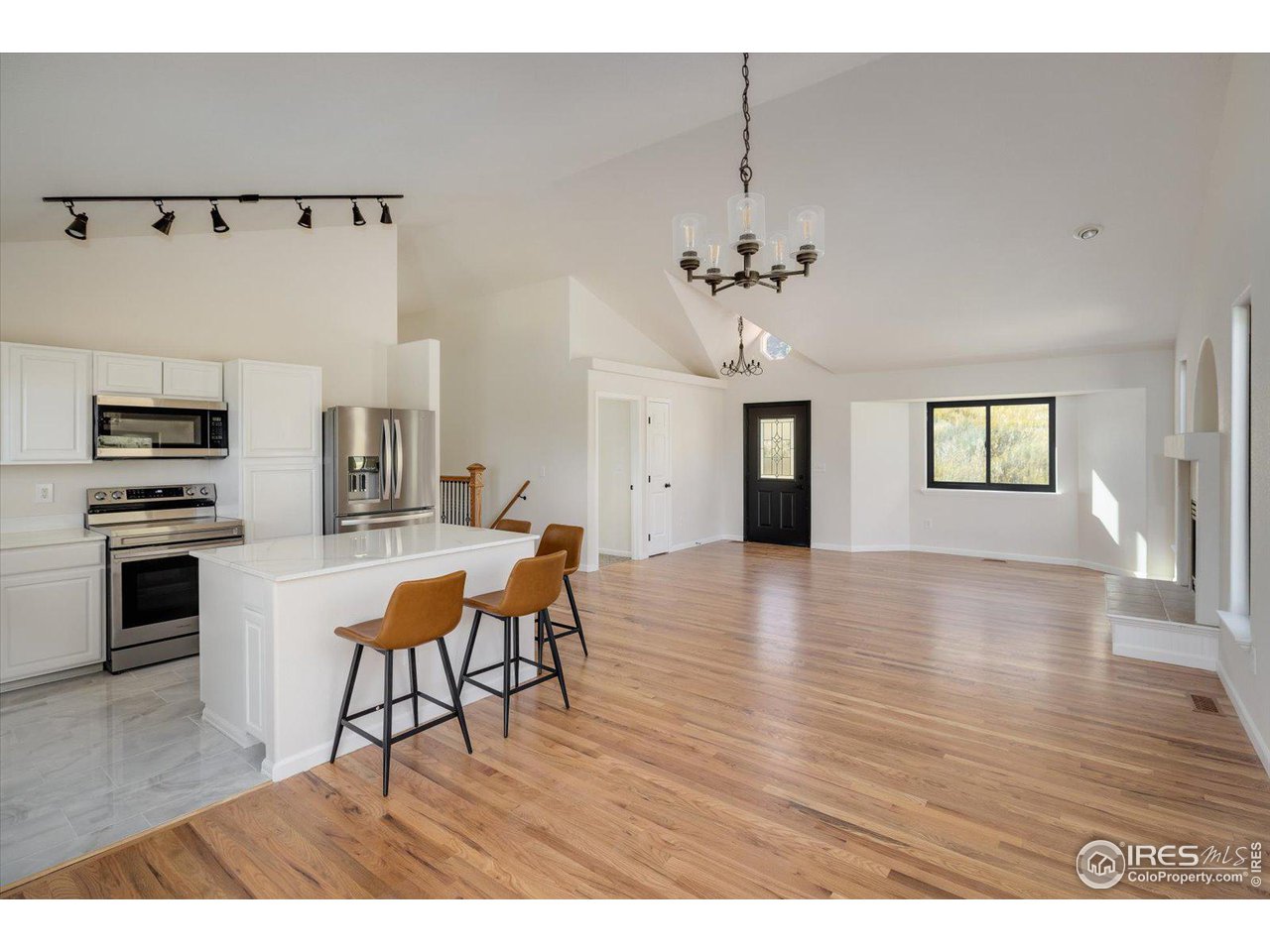147 Makah Lane Lyons, CO 80540 - Photo 9 of 39 a view of a kitchen with furniture and wooden floor