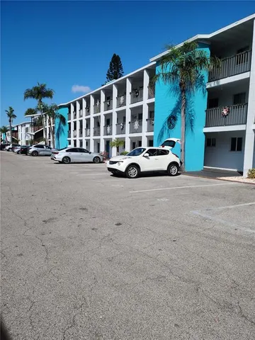 a view of building with outdoor space and parking