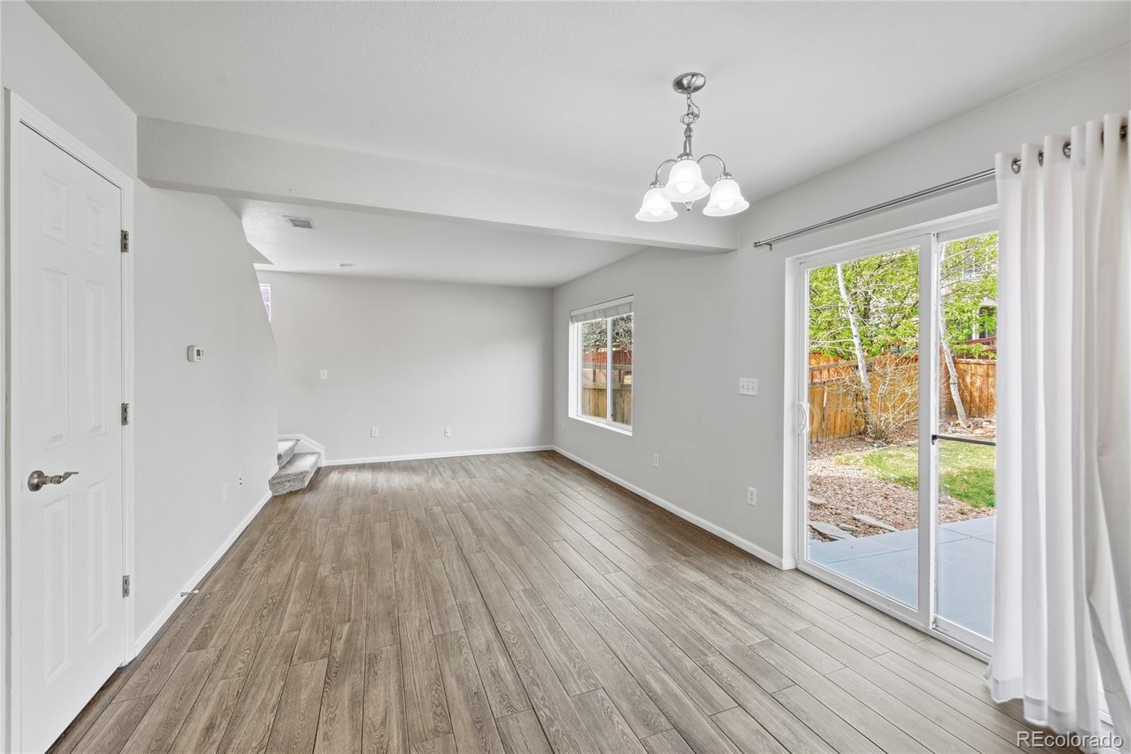 2075 Quartz Street Castle Rock, CO 80109 - Photo 12 of 25 wooden floor in an empty room with a window