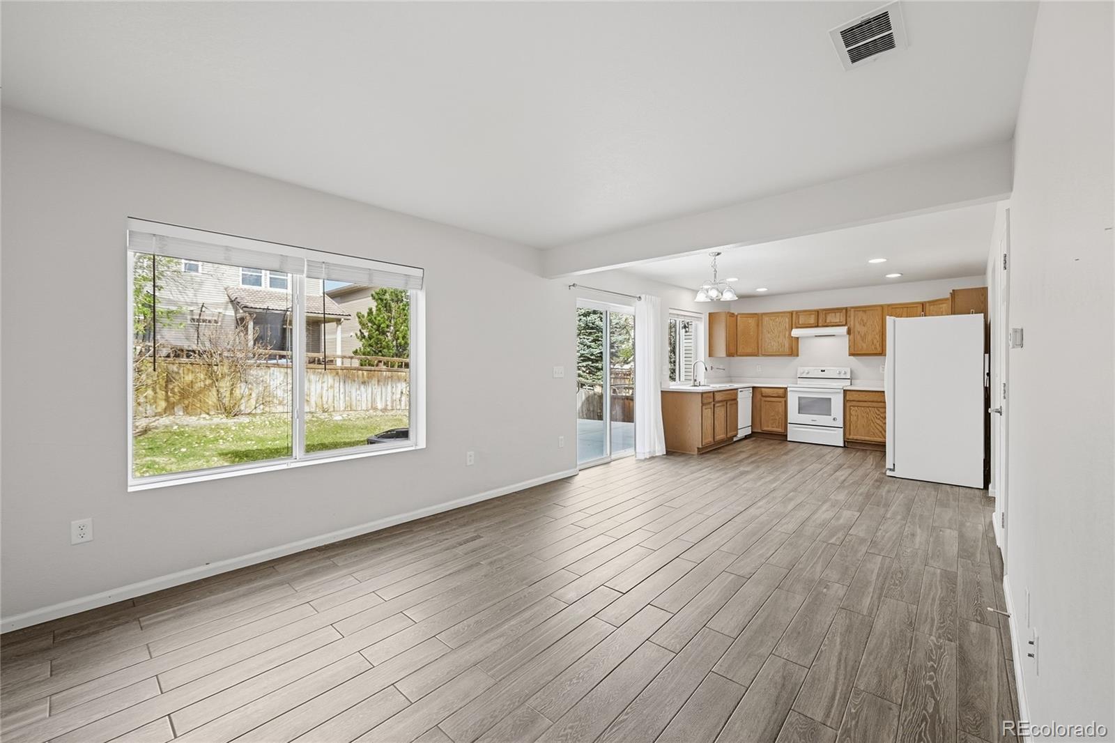 2075 Quartz Street Castle Rock, CO 80109 - Photo 13 of 25 an empty room with wooden floor and windows