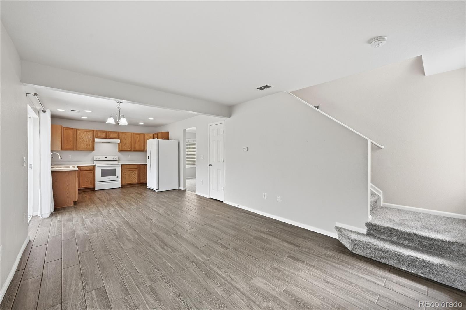 2075 Quartz Street Castle Rock, CO 80109 - Photo 14 of 25 a view of a kitchen with wooden floor and a sink