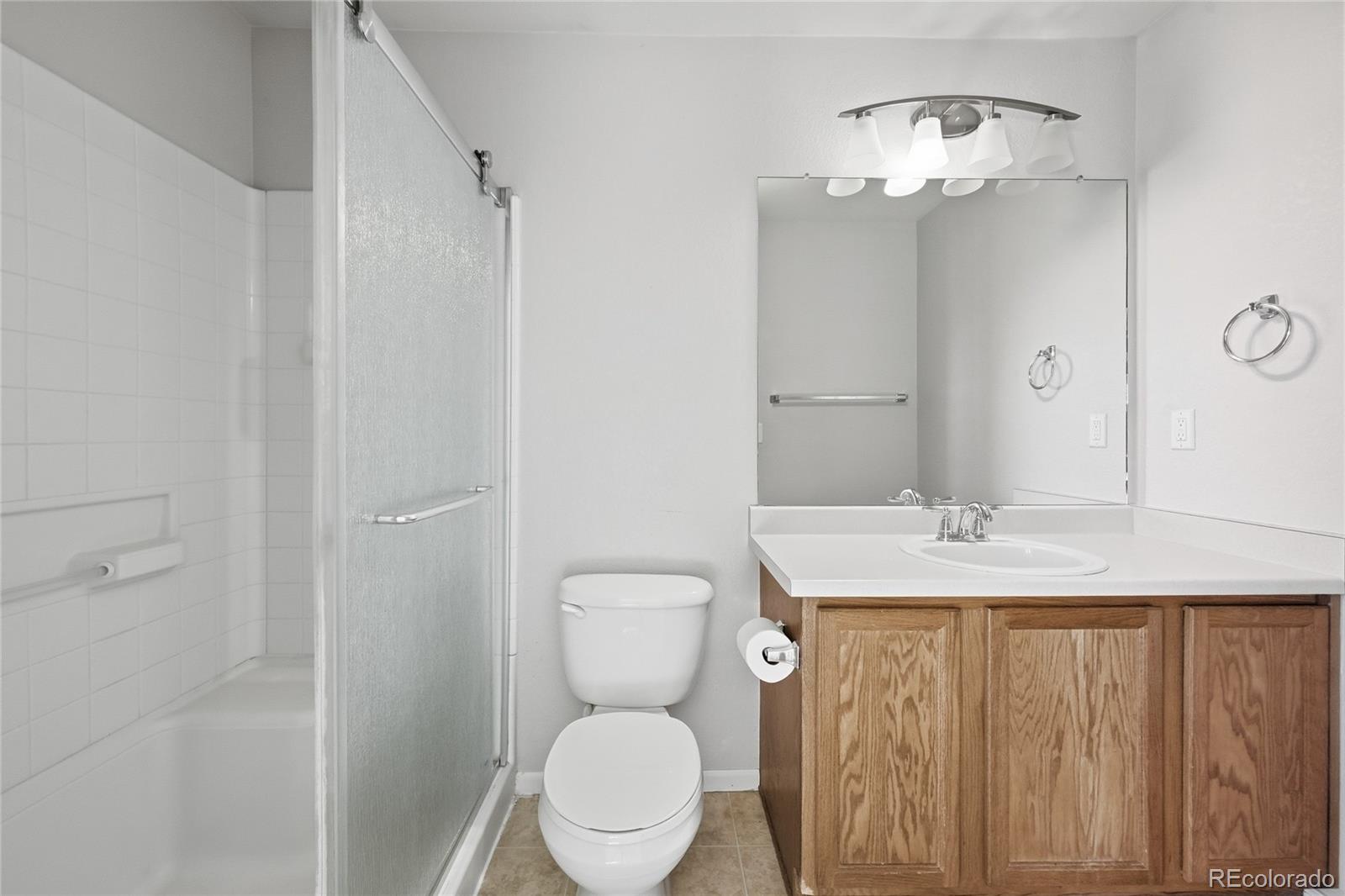 2075 Quartz Street Castle Rock, CO 80109 - Photo 17 of 25 a bathroom with a granite countertop toilet sink and mirror