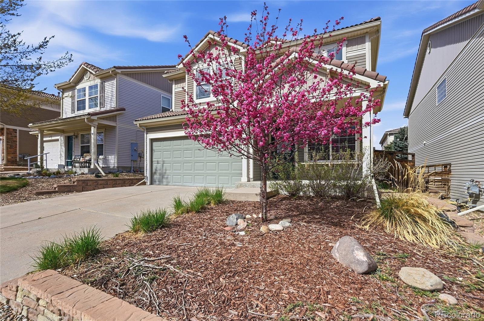2075 Quartz Street Castle Rock, CO 80109 - Photo 2 of 25 a front view of a house with a yard and outdoor seating