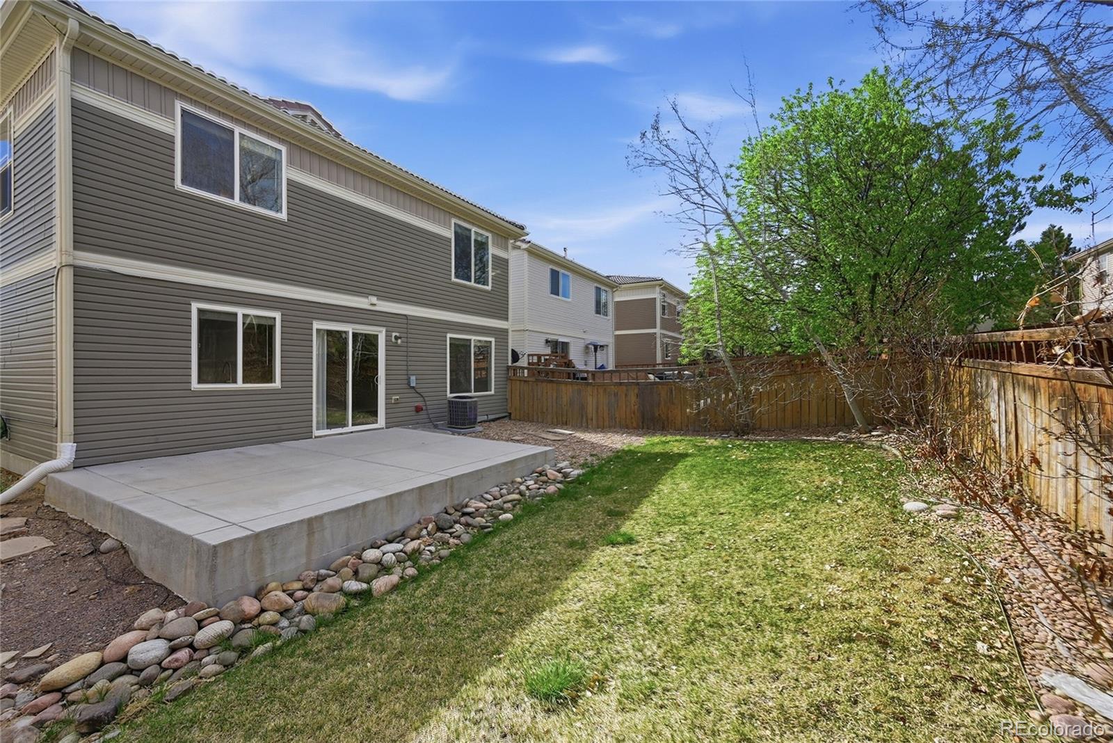 2075 Quartz Street Castle Rock, CO 80109 - Photo 25 of 25 a view of a house with a big yard and large tree
