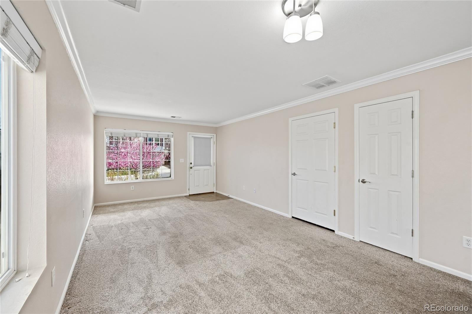 2075 Quartz Street Castle Rock, CO 80109 - Photo 6 of 25 a view of an empty room with a window