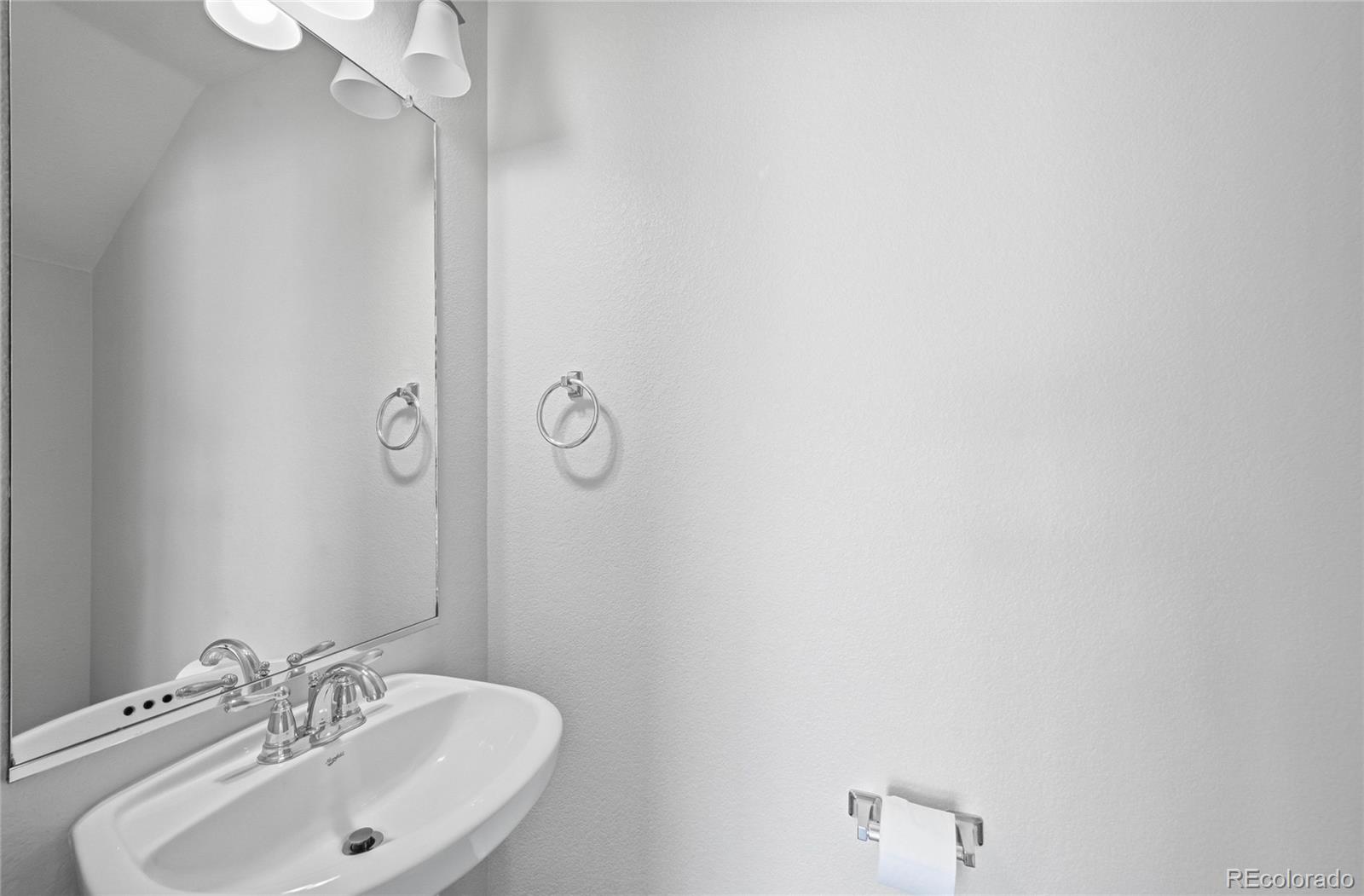 2075 Quartz Street Castle Rock, CO 80109 - Photo 8 of 25 a bathroom with a sink and mirror