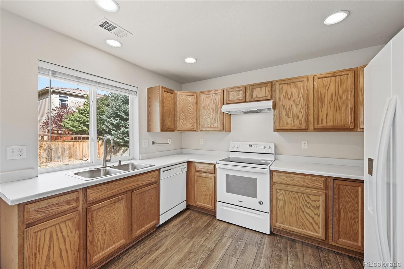 2075 Quartz Street Castle Rock, CO 80109 - Photo 10 of 25 a kitchen with a sink stove and cabinets
