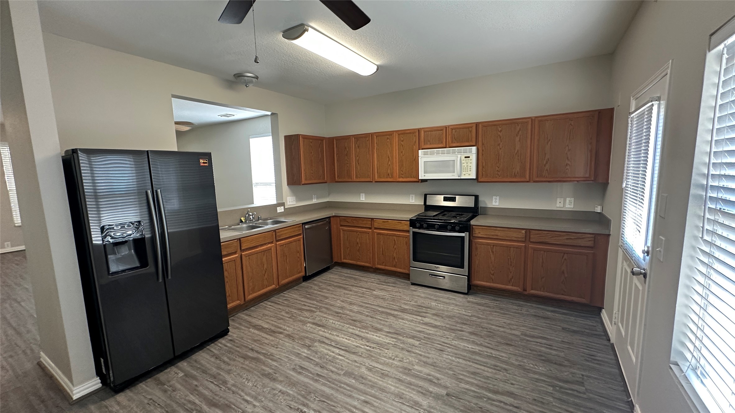 23851 Single Oak Street Spring, TX 77373 - Photo 5 of 15 a kitchen with granite countertop a refrigerator stove top oven and sink