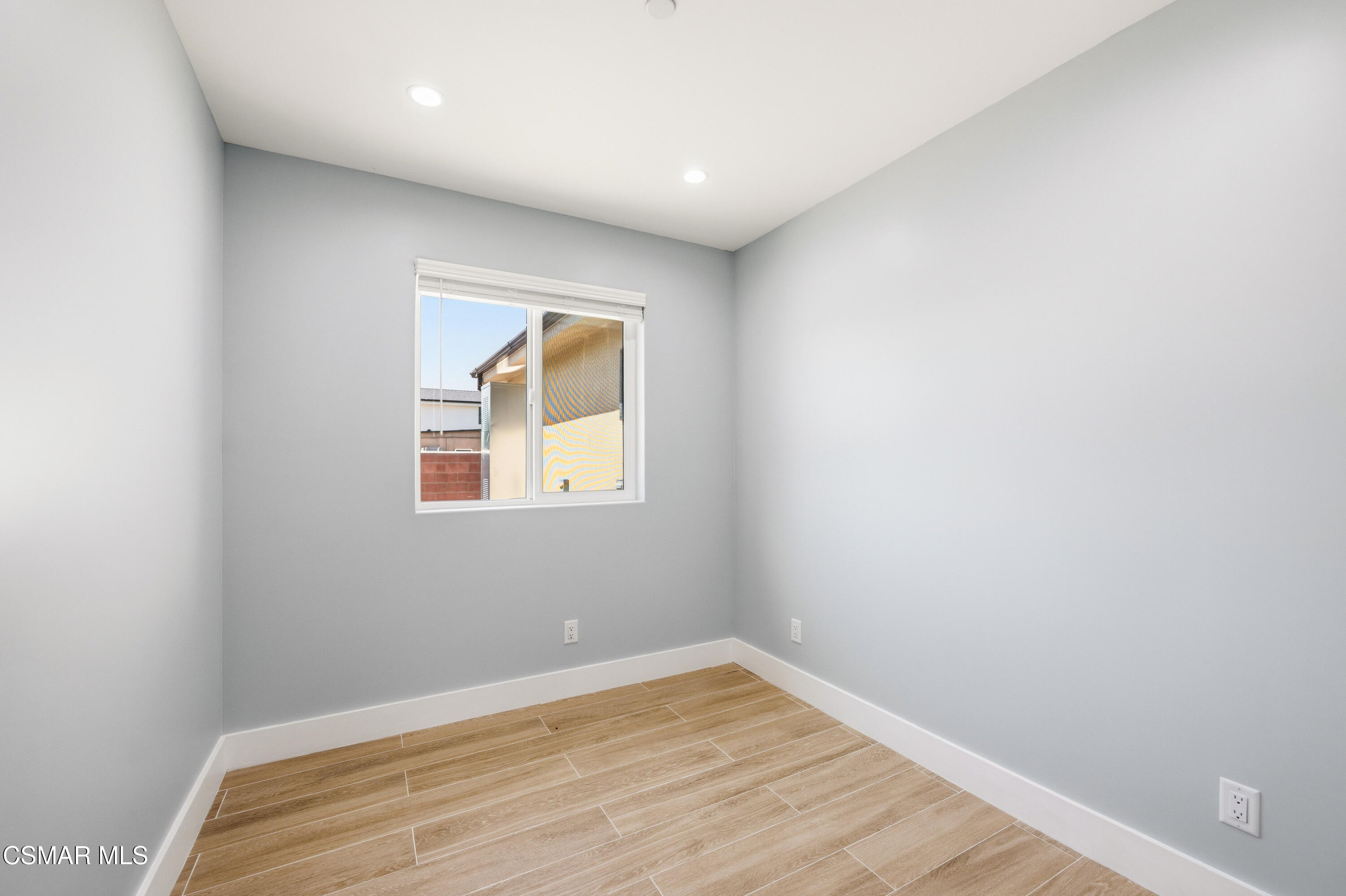 13102 Filmore Street Pacoima, CA 91331 - Photo 11 of 15 a view of an empty room with wooden floor and a window