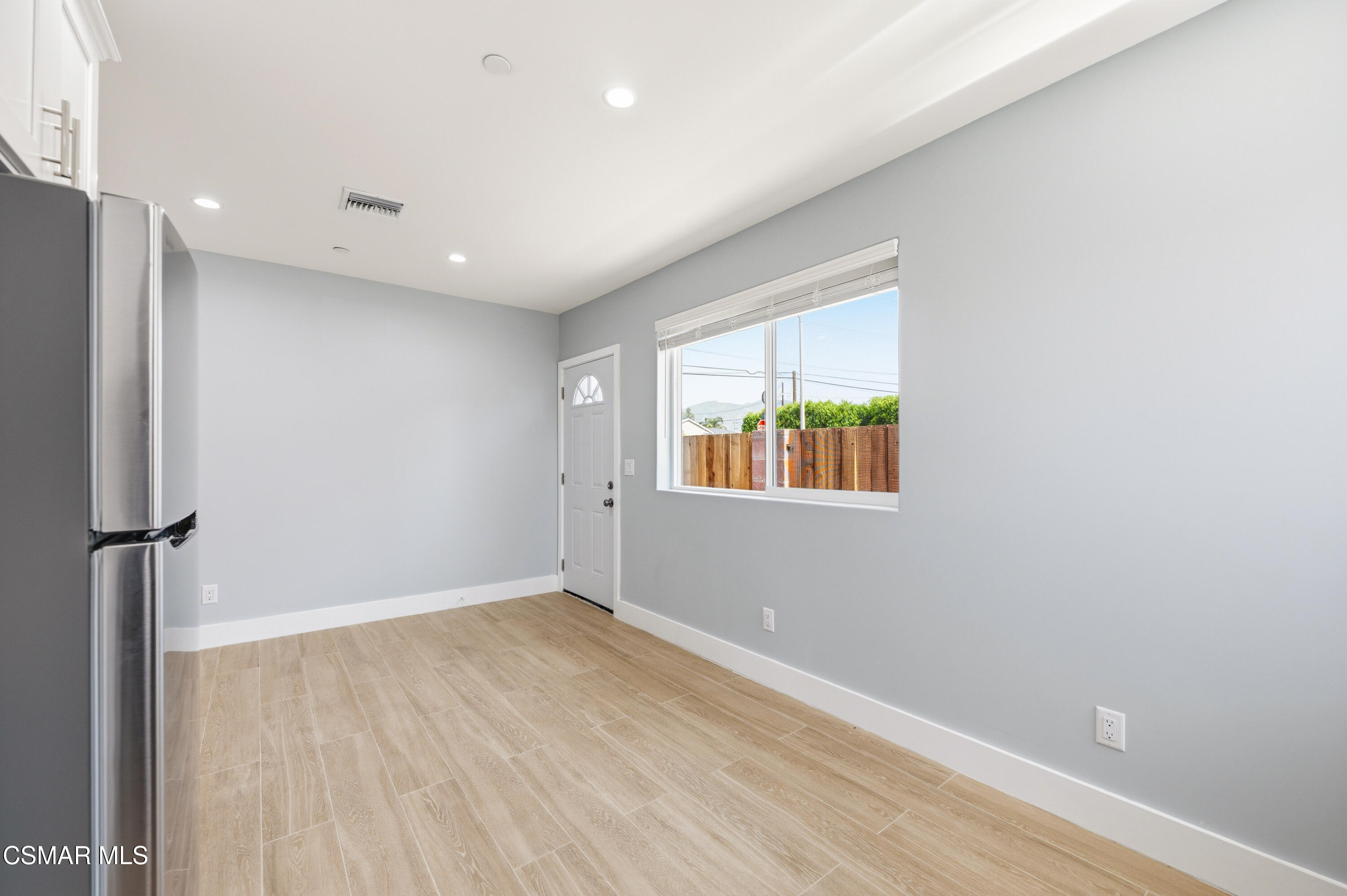 13102 Filmore Street Pacoima, CA 91331 - Photo 5 of 15 an empty room with wooden floor and windows