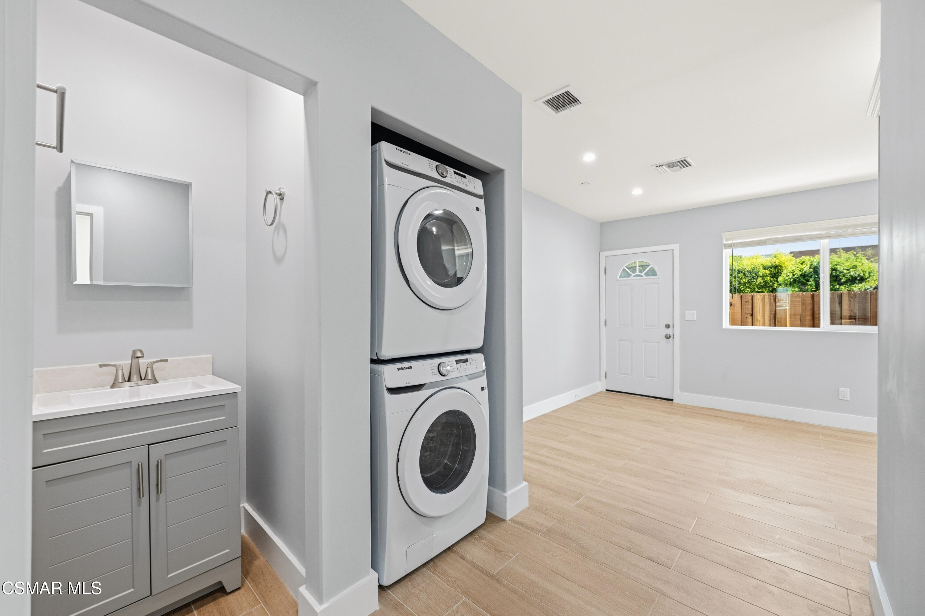 13102 Filmore Street Pacoima, CA 91331 - Photo 7 of 15 a view of a storage and utility room with washer and dryer