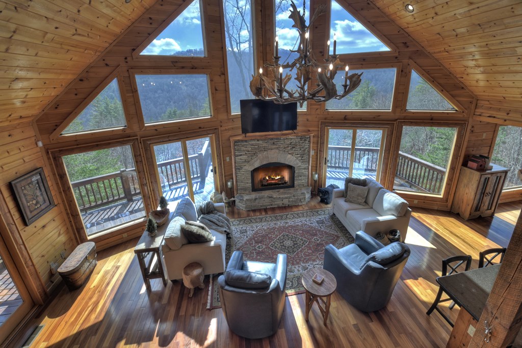 101 Falling Rock Road Cherry Log, GA 30522 - Photo 17 of 70 a living room with furniture a fireplace and a floor to ceiling window