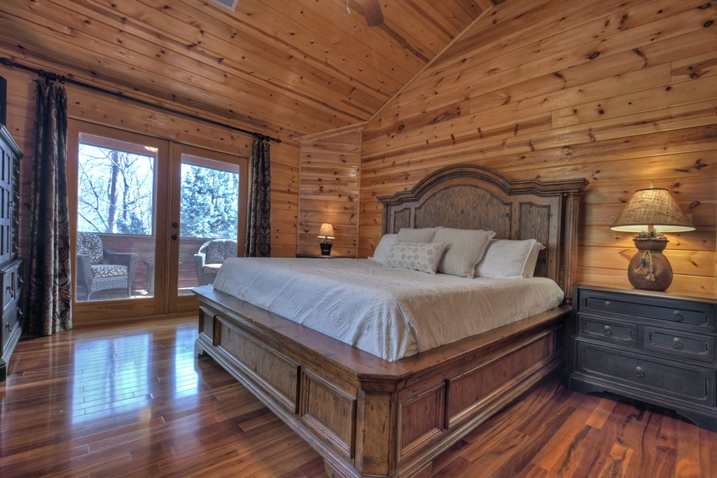 101 Falling Rock Road Cherry Log, GA 30522 - Photo 27 of 70 a spacious bedroom with a bed and wooden floor