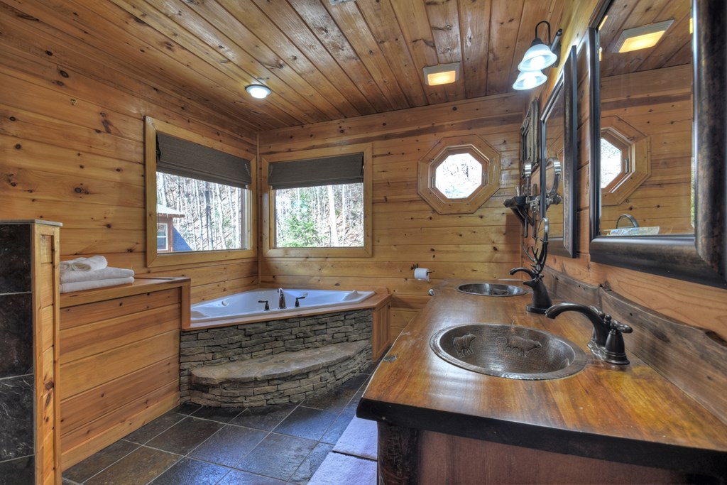 101 Falling Rock Road Cherry Log, GA 30522 - Photo 28 of 70 a bathroom with a sink a vanity and a mirror