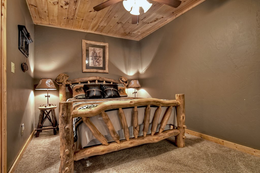 101 Falling Rock Road Cherry Log, GA 30522 - Photo 36 of 70 a bedroom with a bed and a chandelier