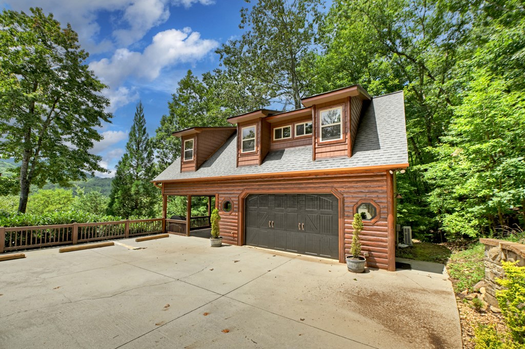 101 Falling Rock Road Cherry Log, GA 30522 - Photo 4 of 70 a front view of a house with a yard and garage