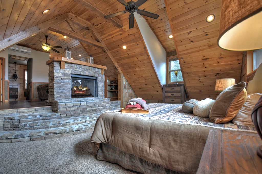101 Falling Rock Road Cherry Log, GA 30522 - Photo 43 of 70 a bedroom with bed and a fireplace