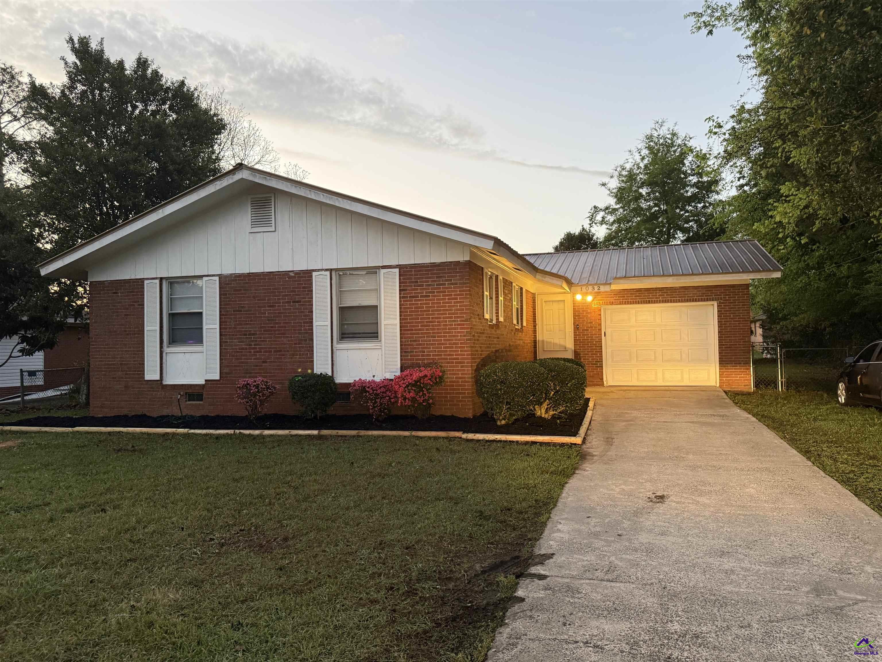 1032 Elberta Road Warner Robins, GA 31093 - Photo 1 of 26 a front view of a house with garden