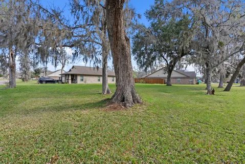 a view of yard with swimming pool and trees