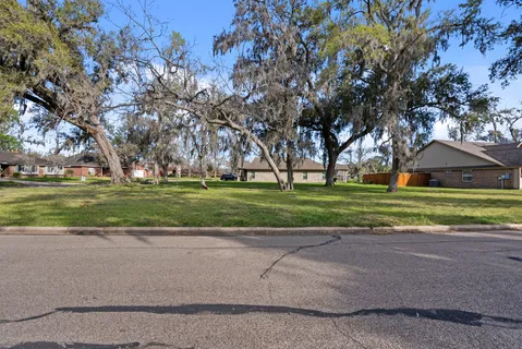 a view of road with large trees