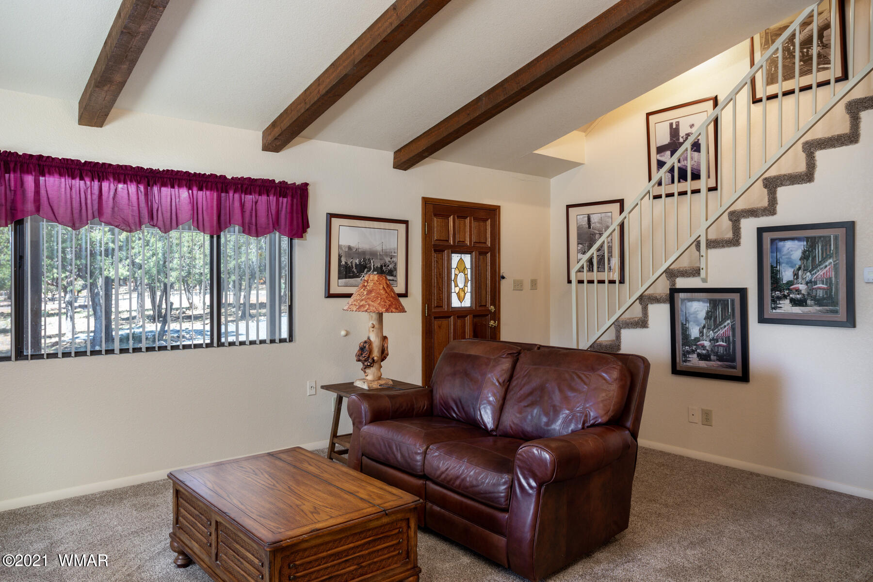 2835 Lodgepole Road Overgaard, AZ 85933 - Photo 5 of 35 a living room with furniture a flat screen tv and a floor to ceiling window