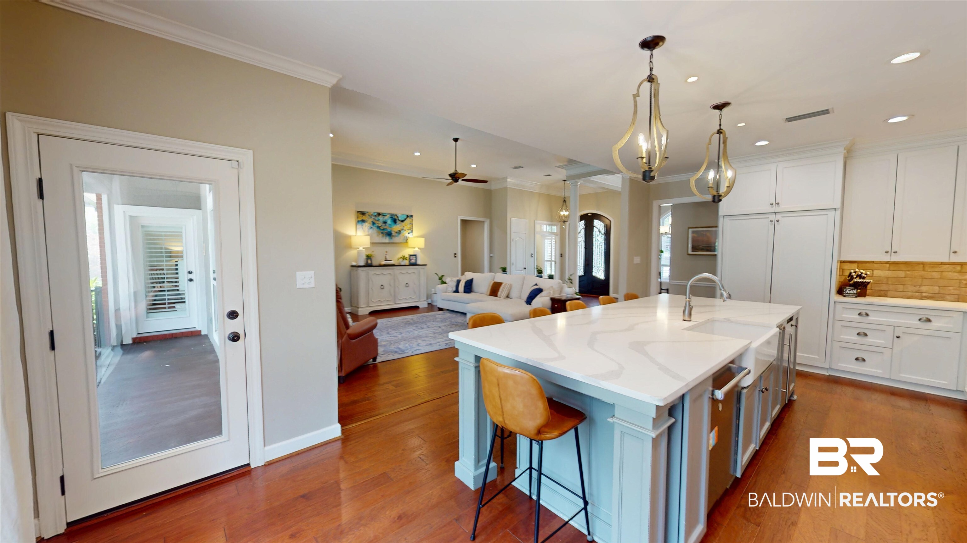 8775 Dawes Lake Road North Mobile, AL 36619 - Photo 11 of 59 Kitchen with decorative backsplash, white cabinets, wood finished floors, a center island with sink, and ornamental molding