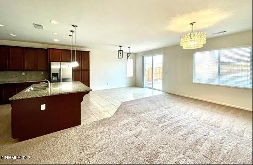 1987 Wind Walker Drive Reno, NV 89521 - Photo 11 of 16 a view of a kitchen with kitchen island granite countertop wooden cabinets and a sink