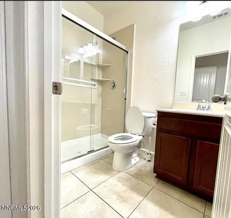 1987 Wind Walker Drive Reno, NV 89521 - Photo 4 of 16 a bathroom with a toilet a sink and a mirror