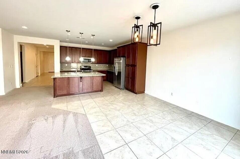 1987 Wind Walker Drive Reno, NV 89521 - Photo 10 of 16 a kitchen with stainless steel appliances kitchen island granite countertop a refrigerator and a sink