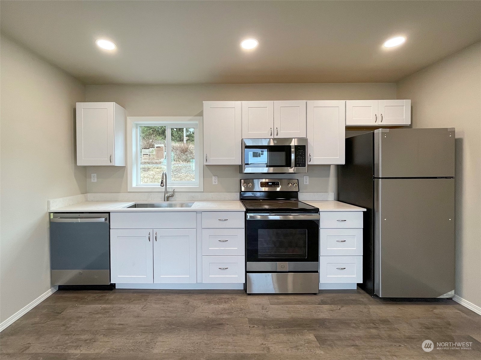 2023 Atterberry Road Sequim, WA 98382 - Photo 11 of 40 a kitchen with granite countertop white cabinets and stainless steel appliances