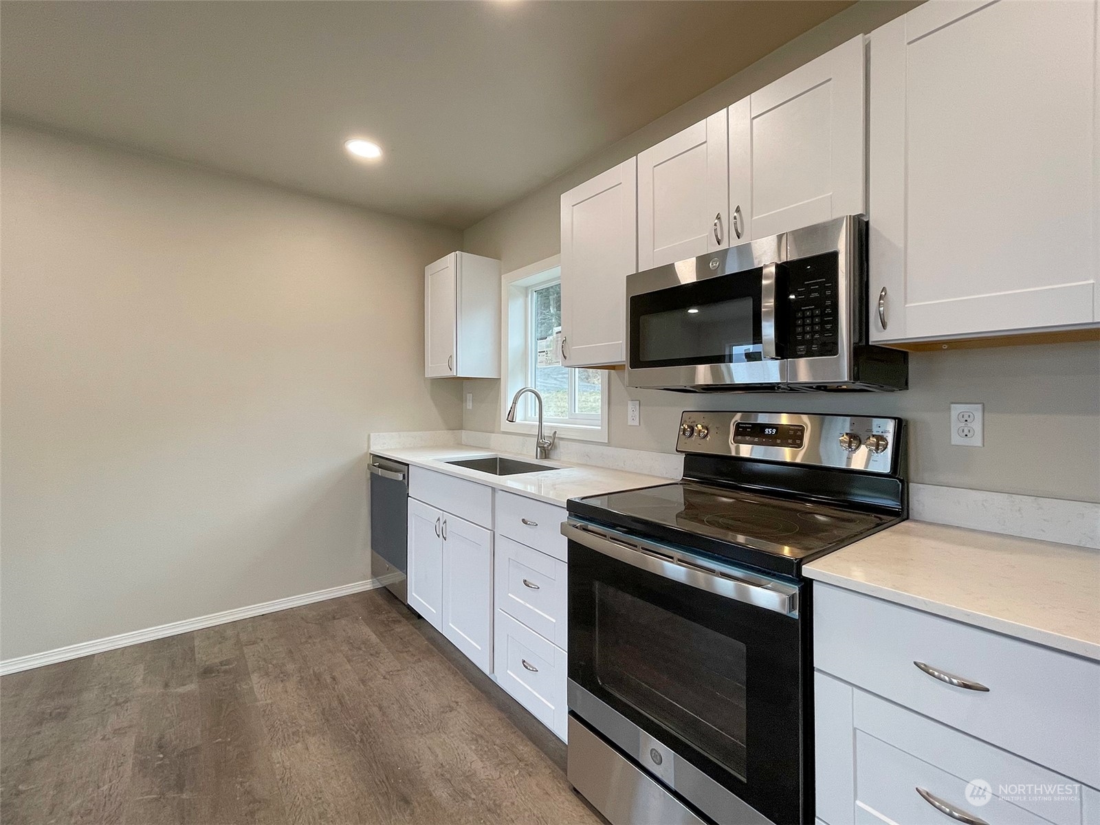 2023 Atterberry Road Sequim, WA 98382 - Photo 13 of 40 a kitchen with stainless steel appliances a stove a microwave sink and cabinets