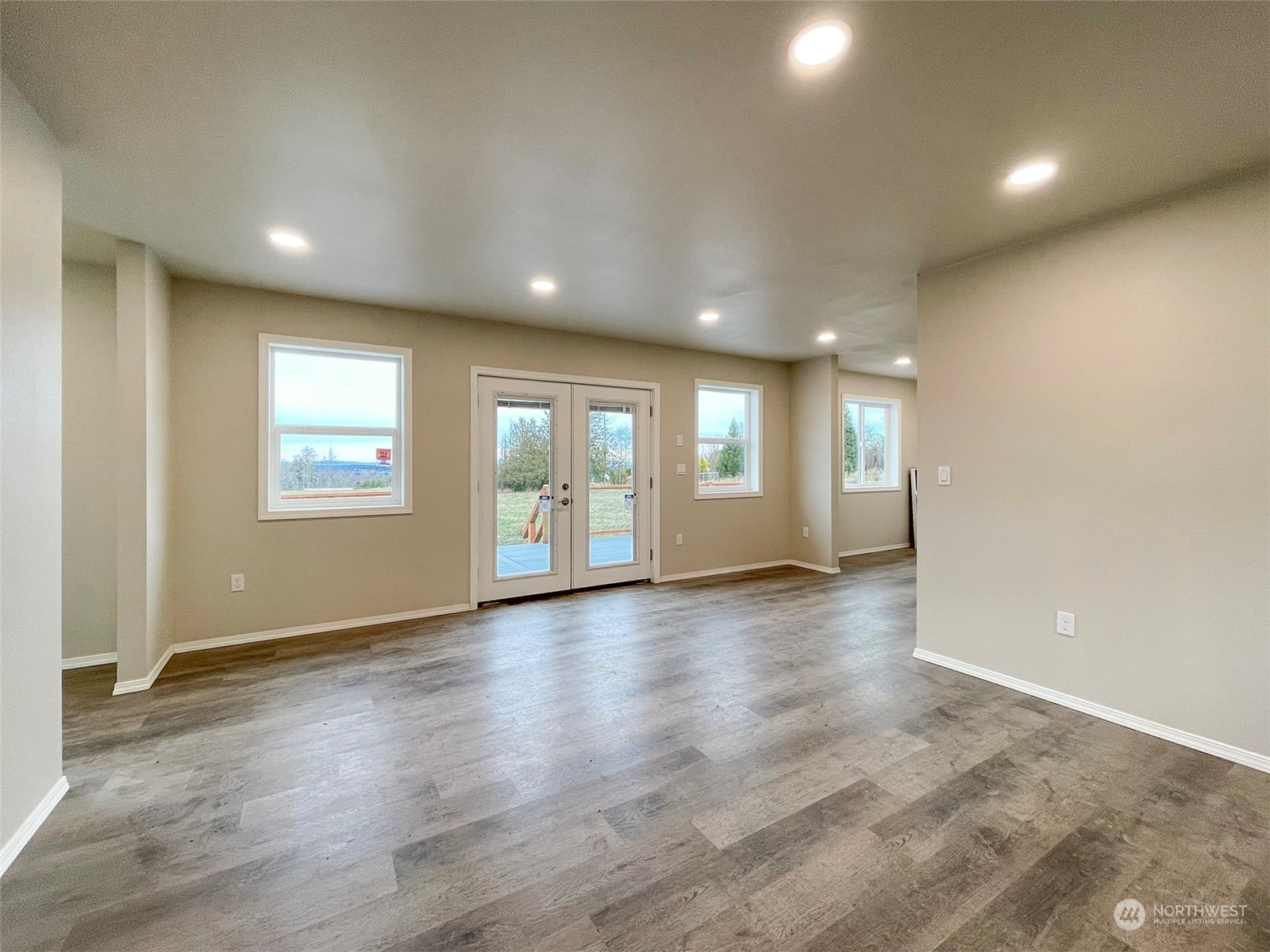 2023 Atterberry Road Sequim, WA 98382 - Photo 14 of 40 an empty room with wooden floor and windows