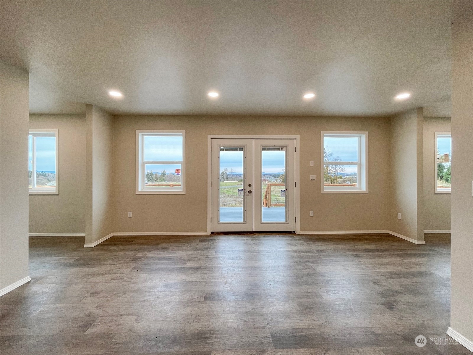 2023 Atterberry Road Sequim, WA 98382 - Photo 15 of 40 an empty room with wooden floor and windows