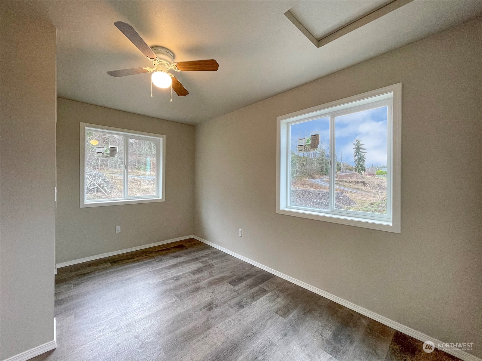 2023 Atterberry Road Sequim, WA 98382 - Photo 18 of 40 a view of an empty room with wooden floor and a window