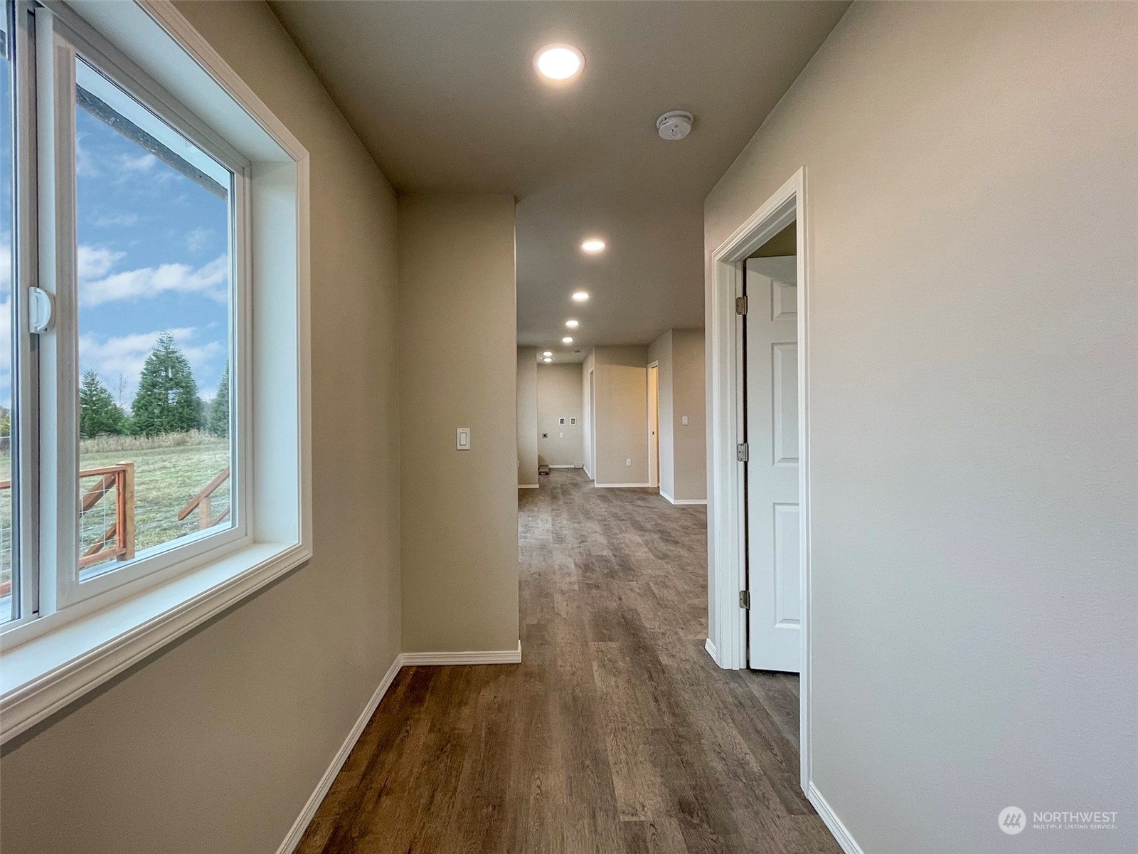 2023 Atterberry Road Sequim, WA 98382 - Photo 22 of 40 a view of hallway with a large window and wooden floor