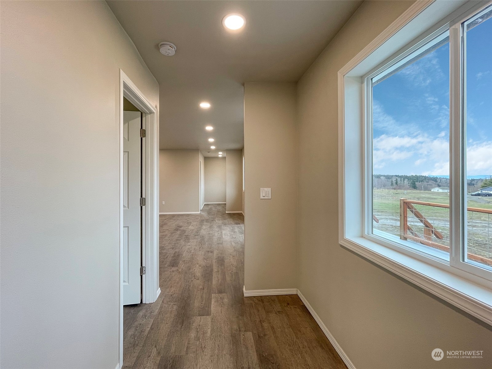 2023 Atterberry Road Sequim, WA 98382 - Photo 30 of 40 a view of hallway with a door and wooden floor