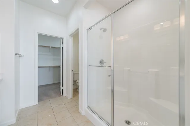 a bathroom with a shower and a glass door